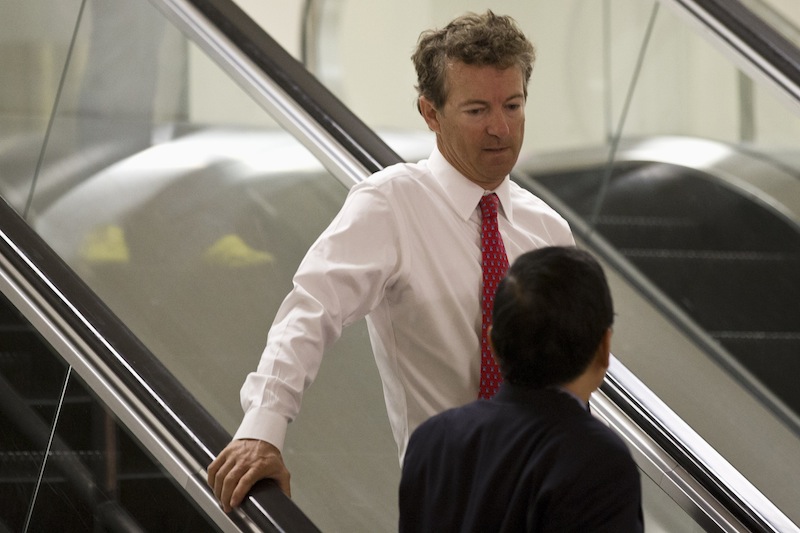 Sen. Rand Paul, D-Ky. rides an escalator on Capitol Hill in Washington, Tuesday, Sept. 3, 2013, on his way to attend a joint Senate and House intelligence closed-door briefing on Syria. A vote for war can make or break a White House hopeful. The politically fraught decision weighs on potential 2016 Republican candidates Sens. Rand Paul and Marco Rubio. (AP Photo/Jacquelyn Martin)