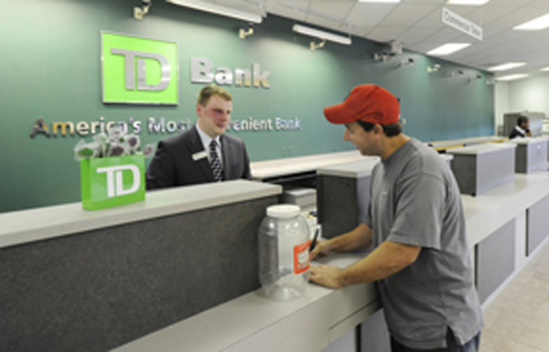 A TD Bank customer service representative helps a new customer Matthew Hodgins open an account. Some TD Bank customers in New Hampshire and Vermont got other people’s financial information with their own bank statements.
