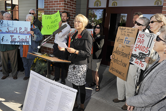 Protect South Portland, a group opposing the exporting of so-called tar sands oil out of Casco Bay, held a news conference Wednesday to list dozens of local businesses supporting their efforts. Deb Hutson, a Realtor with Keller-Williams Real Estate, speaks at the news conference.