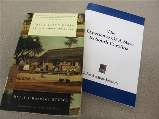 Copies of Harriet Beecher Stowe's "Uncle Tom's Cabin" and John Andrew Jackson's "The Experience of a Slave in South Carolina" are seen in this Aug. 29, 2013 photo taken at the Charleston County Library in Charleston, S.C. A professor of American literature at Clemson University, Susanna Ashton, says her research indicates Stowe harbored Jackson, then a fugitive slave, in her Maine home just before she started writing her novel "Uncle Tom's Cabin." Ashton says Jackson shared his painful experiences of slavery prompting Stowe to write the novel.