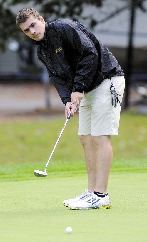 Maranacook Community School’s Matt Delmar keeps his eyes on the ball in a match against Mt. Blue on Monday at the Augusta Country Club in Manchester. Delmar shot a 40 to share medalist honors with teammate Luke Ruffing. The Black Bears won 175-227.