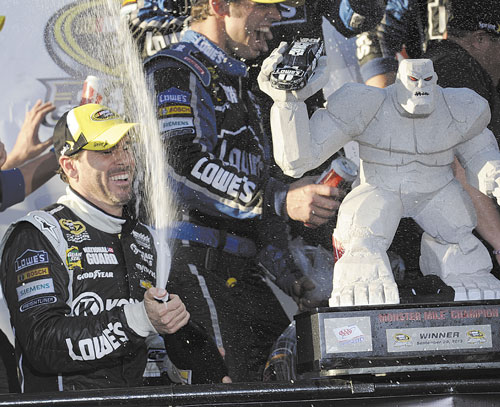 PARTY TIME: Jimmie Johnson celebrates in Victory Lane after winning a NASCAR Sprint Cup Series race Sunday at Dover International Speedway in Dover, Del.