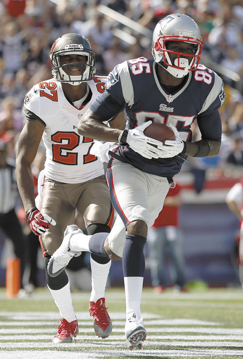 BIG DAY: New England Patriots wide receiver Kenbrell Thompkins (85) makes his second touchdown catch in front of Tampa Bay Buccaneers cornerback Johnathan Banks in the first half Sunday in Foxborough, Mass.