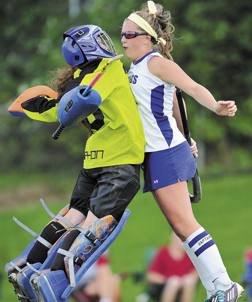 NICE JOB: Lawrence High School teammates Emily Tozier, left, and Abby King celebrate a first-half goal against Mt. Blue High School on Thursday at Lawrence High School in Fairfield.