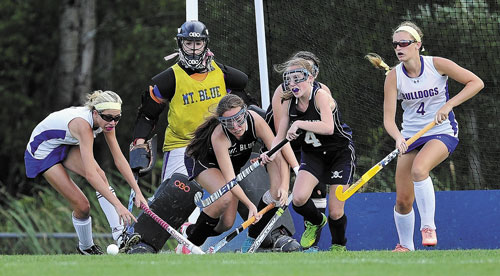 FIGHT IS ON: Lawrence High School’s Hallee Parlin, far left, and McKenna Rogers, right, battle for a rebound with Mt. Blue defenders Taylor Hollingsworth, left center, and Leah St. Laurent, right center, during a game Thursday in Fairfield. Mt. Blue goalie Rileigh Blanchet watches the action.