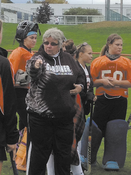 LEADING THE WAY: Gardiner field hockey coach Moe McNally, shown instructing a player at halftime, won her 400th career game Tuesday as the Tigers defeated Erskine, 4-0. McNally has been coaching Gardiner since 1979. Behind McNally are Emalee Couture, Emily Malinowski and Kaylin Mansir.