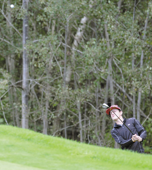 BLAST: Maranacook Community School’s Luke Ruffing hits a ball onto the green Monday during a golf match against Mt. Blue High School at the Augusta Country Club in Manchester. Ruffing shot a 40 to share medalist honors with teammate Matt Delmar. The Black Bears won 175-227.