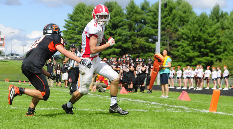Staff photo by Joe Phelan HE’S IN: Cony wide receiver Mitchell Bonenfant scores a touchdown on a pass from Ben Lucas as Brewer defensive back Austin Pagnozzi, left, tries to stop him Saturday at Alumni Field in Augusta.
