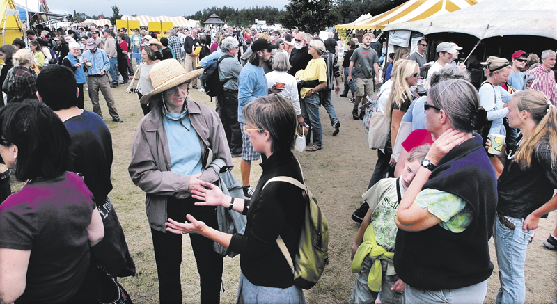 Crowds of people gather during the Common Ground Country Fair in Unity in 2011. Organizers are planning to erect a larger, more powerful temporary cellphone tower during the fair's Sept. 20-22 run, to serve the anticipated 10-fold increase in the town's population during the fair.