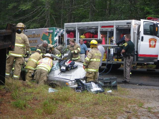 Rescue responders work to extract the occupants of a one-car crash in Shapleigh on Monday, Sept. 2, 2013.