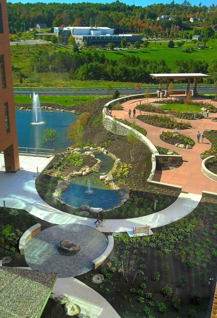 People stroll the gardens during a tour of the Alfond Center for Health today in Augusta. The Alfond Center for Cancer Care can be see in the background.