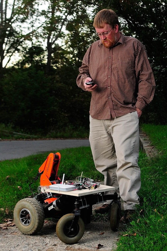 Paul Fowlerl uses his cellphone on Sept. 17 to operate a robot he created in Gardiner.