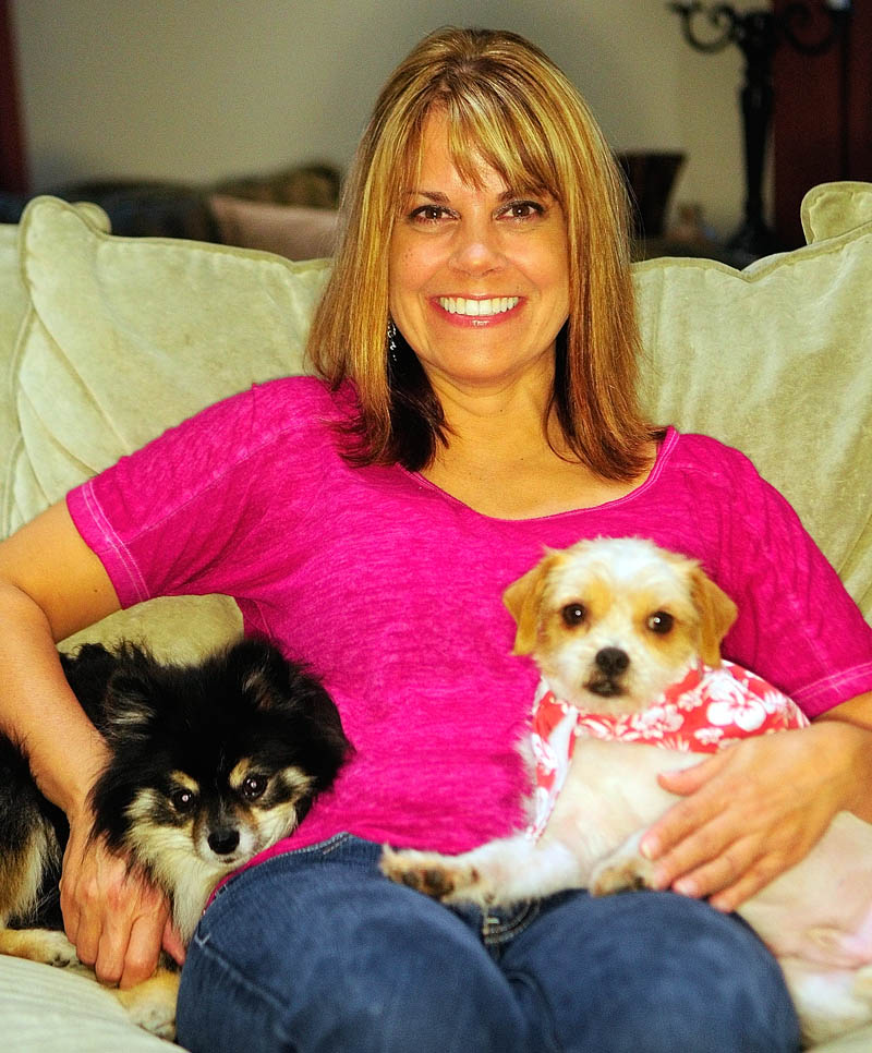 Stephanie Towle and her dogs Sophia Loren, left, and Murphy, sit on the couch on Saturday at her Chelsea home. Towle recently adopted Murphy through Puppy Love Inc., a rescue group that brought him to Maine from Louisiana.