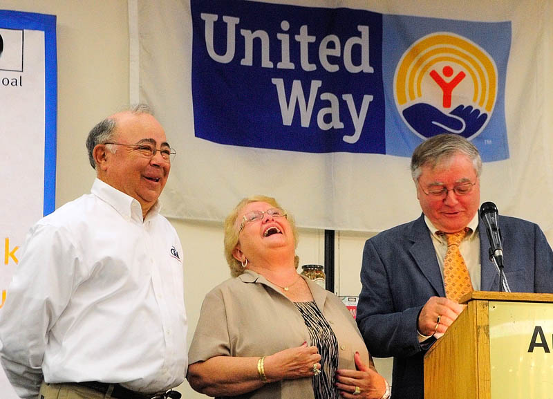 Charlie and Nancy Shuman laugh at something Rob Gordon, executive director of the United Way of Kennebec Valley, said while presenting them the Norm Temple Award on Wednesday during the United Way of Kennebec Valley breakfast event at the Augusta Civic Center.