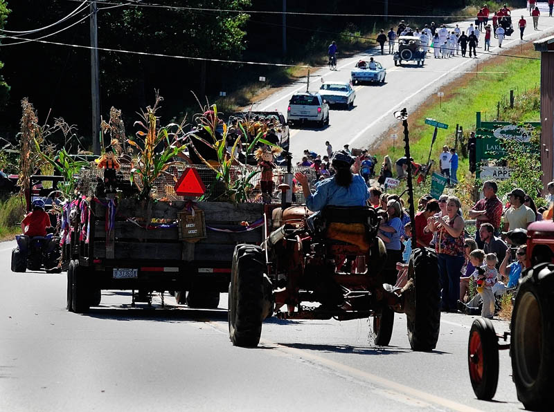 People watch at Lakeside Orchards as the 10th annual Manchester Apple Festival parade goes past on Saturday, on Route 17 in Manchester.