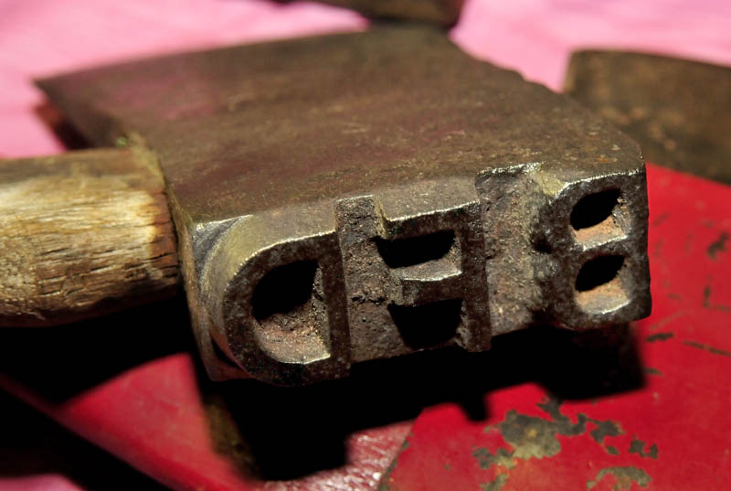 An ax head in Howard Hardy's collection bears the initials "BFD," for the logging company Bert, Forester and Dixfield. The tool was used to mark log ends during river drives, Hardy said.