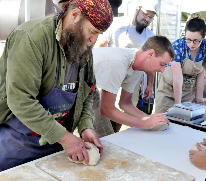 Dusty Dowse, left, and other bakers prepare dough Thursday for 500 loaves of rye bread to feed volunteers at the upcoming three-day Common Ground Country Fair in Unity. Others making bread, from left, are: Jeff Dec, Lily Joslin and Dan Rivera, in background.