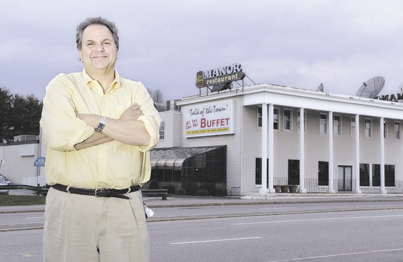 Peter Martin stands in front of the John Martin's Manor Restaurant on College Avenue in Waterville in 2005, shortly before selling the establishment to a Georgia company.