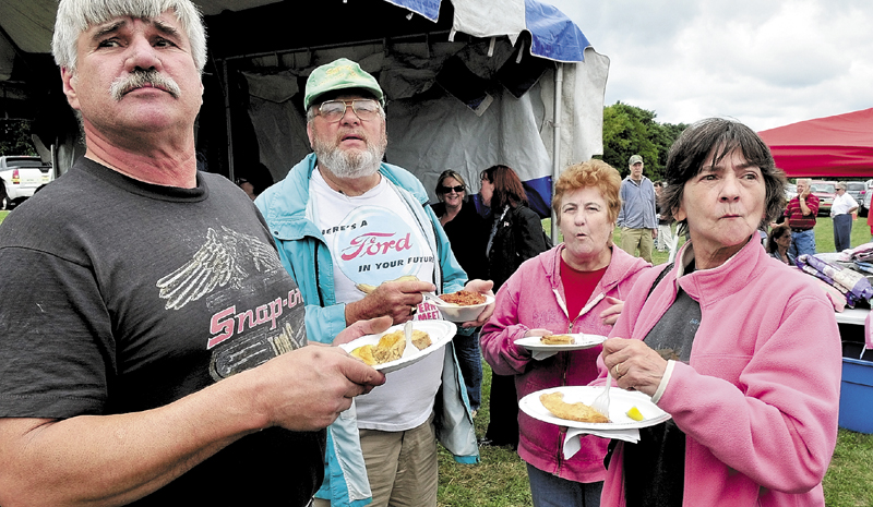 Ray Morrow, left, and his wife, Brenda, at right, look up with Glenn Bryon and Antoinette Gilbert, while sampling foods as winners of the tourtiere contest are announced during the 8th annual Franco-American Family Festival in Waterville in 2010.