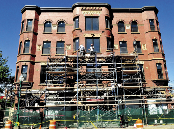 Workers perform masonry and install windows on the Gerald Hotel in Fairfield on Sept. 9.