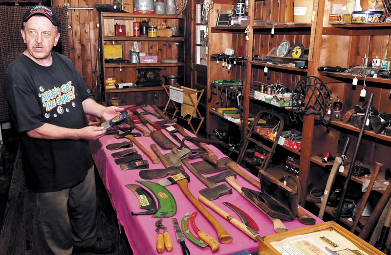 Howard Hardy speaks inside his shop in Hinckley, about his large collection of old axes and cutting tools manufactured by former Oakland tool companies.
