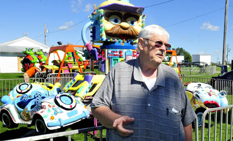 Jon Whitten speaks about his 60-year involvement with the Clinton Lions Club Fair as the midway is set up on Wednesday.