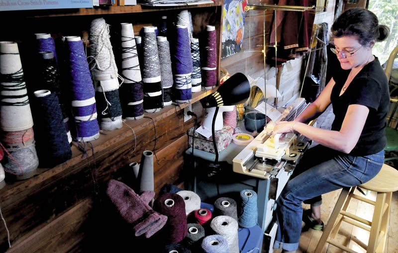 Karin Schott operates her hand-powered knitting machine at her home in New Sharon. Schott will display her knitting machine and skills at the Lewiston-Auburn Mini Maker Faire on Saturday.