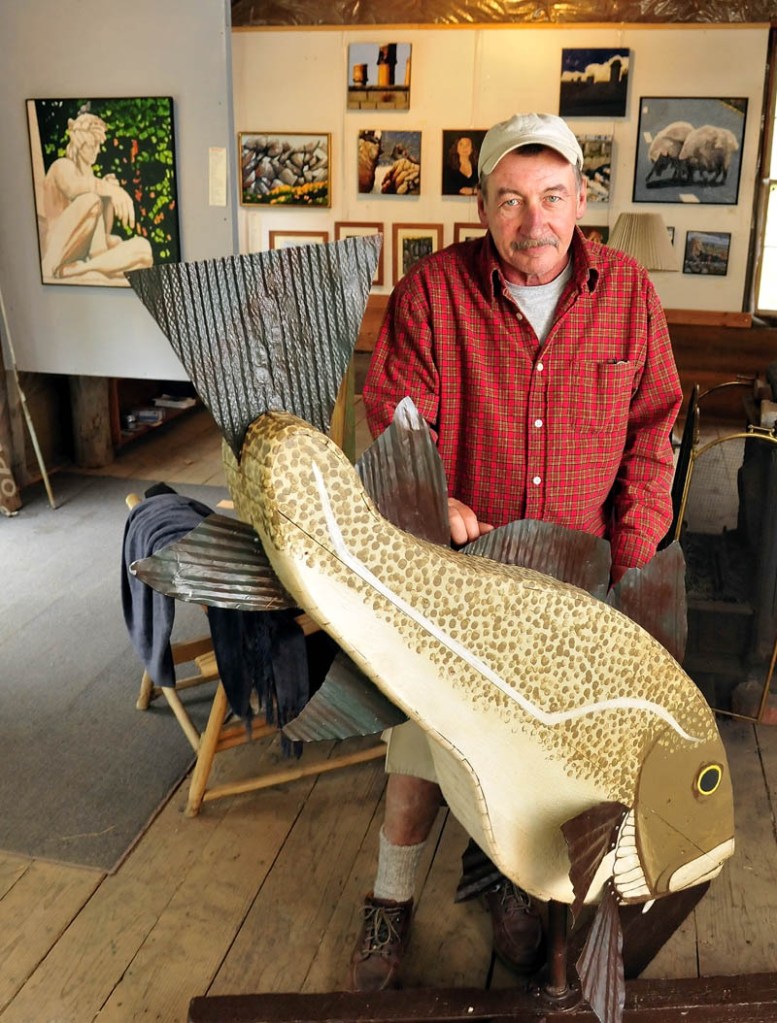 Artist Kevin James with his latest work, titled "My Cod Piece," at his Kevin James Studio Gallery in Cornville on Monday. James is one of 17 artists participating in the Open Studio Tour this Saturday.