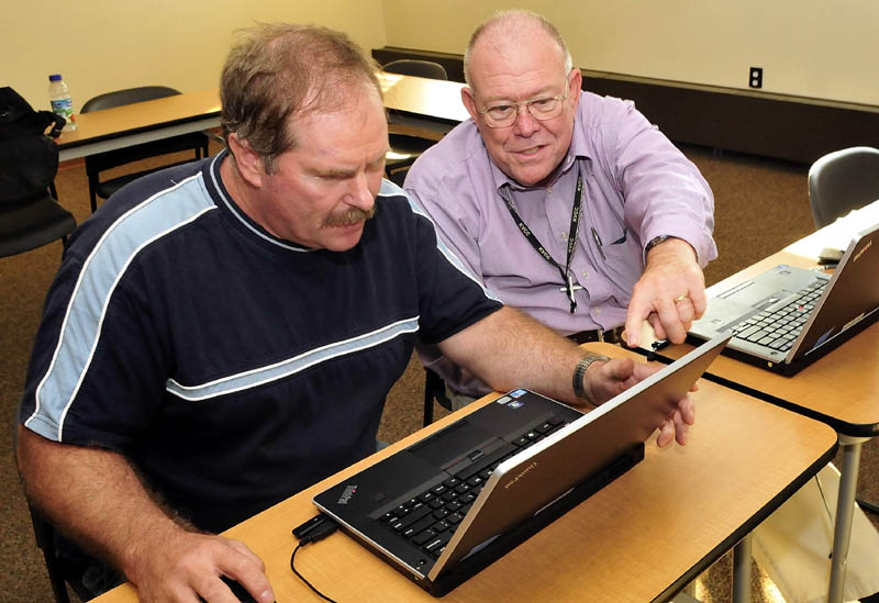 Laton Edwards, right, works with Edwin Weeks on a computer at the Waterville Public Library recently.
