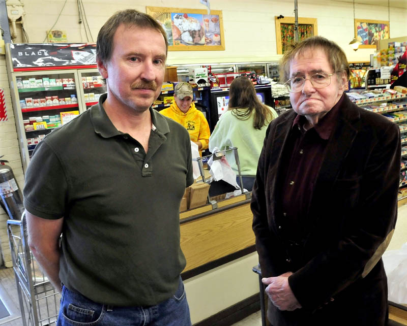Robert Pleau, left, and his father Bill, owners of Pleau's Market in Winslow, today are getting ready for a mandated tax increase, which will raise sales tax a half-percent to 5.5 percent and meals and lodging tax up a percentage point to 8 percent. Cashier Lateaka Brewster, right, assists customers in background.