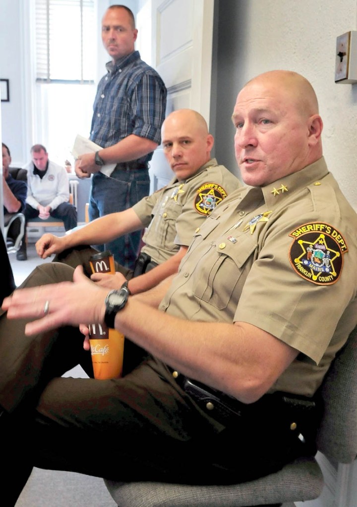 Franklin County Sheriff Scott Nichols, front, proposes withholding a county jail payment to the Board of Corrections during a Franklin County Commission meeting in Farmington today. Deputy Chief Steve Lowell is beside Nichols and Jail Administrator Doug Blauvelt is standing in the background.