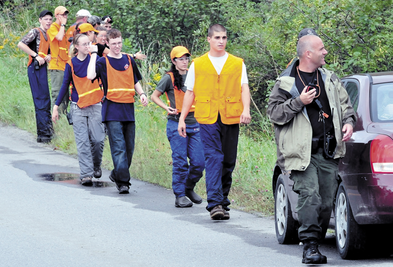 Members of Dirigo and Unity College Search and Rescue teams spread out before searching a field and woods near 344 East Benton Road in Benton for missing Arthur Wakeman, 86, on Thursday.