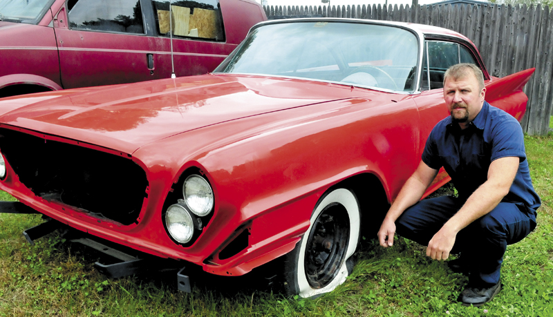Dominick Rinaldi ll beside a rare 1961 Chrysler 300 G vehicle undergoing restoration that was vandalized last weekend at his Rinaldi and Sons shop in Skowhegan. Rinaldi said the vehicle sustained four slashed tires, a broken windshield and the roof and hood were dented after being walked on. Several other cars and a boat were also damaged.