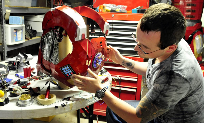 Tom Lemieux, of Oakland, works on the chest armor of his Iron Man suit.