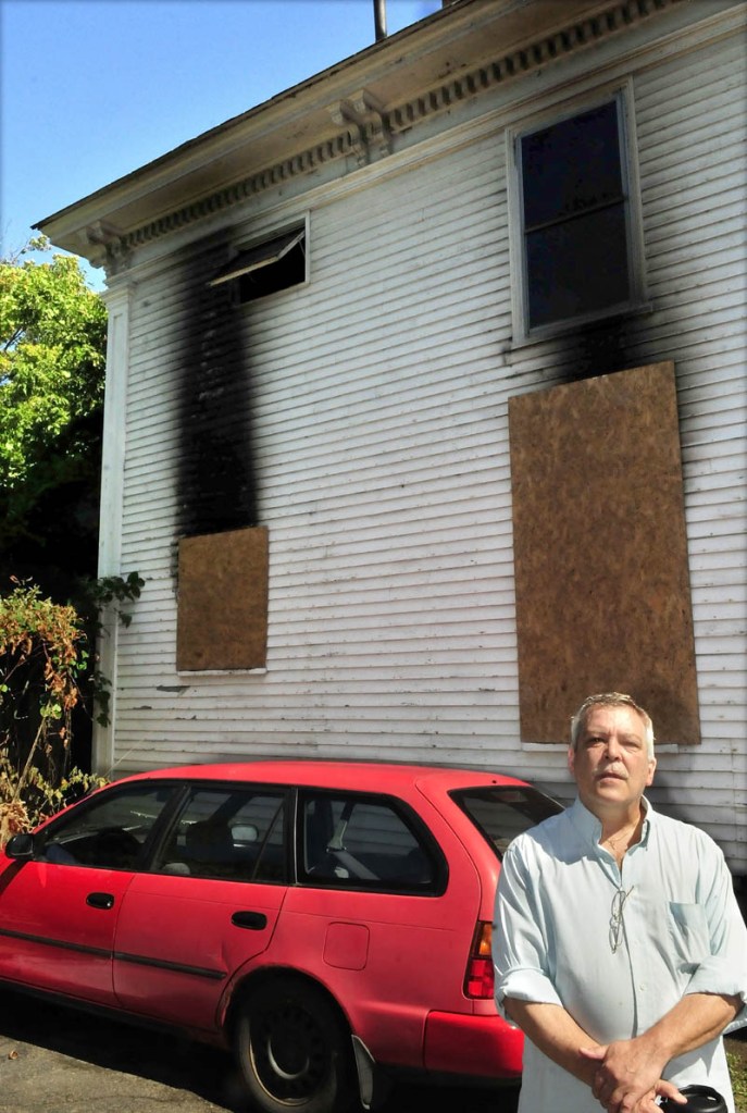 Wes Berry's home was only feet from the house that was destroyed by fire on August 25 on Elm Court in Waterville. Exploding window glass covered his driveway and vehicle. Berry and other neighbors want the building razed.