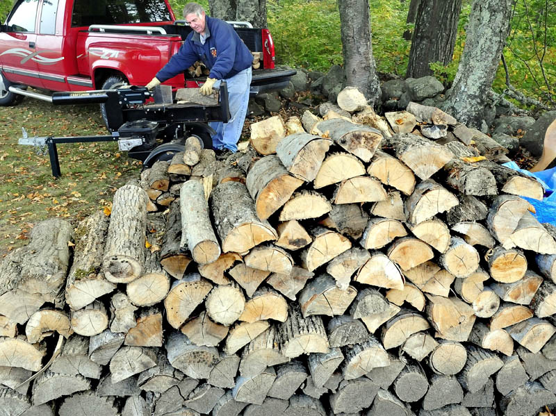 Doug Oliver splits firewood in Farmington today. Many homeowners are busy getting their wood supply indoors as winter never seems too far away in Maine.
