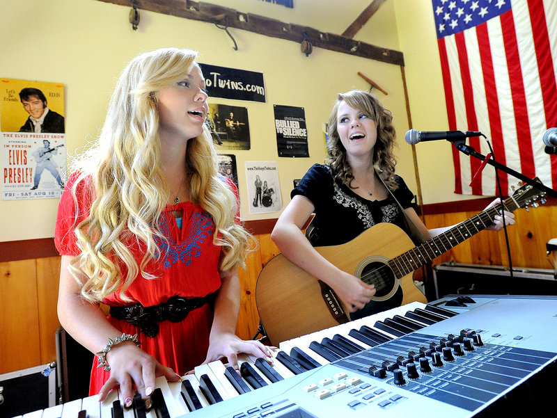 Identical twins Katherine, left, and Kristen Veayo, 18, play a song at their home in Winthrop. Music became their biggest source of comfort after years of being bullied.
