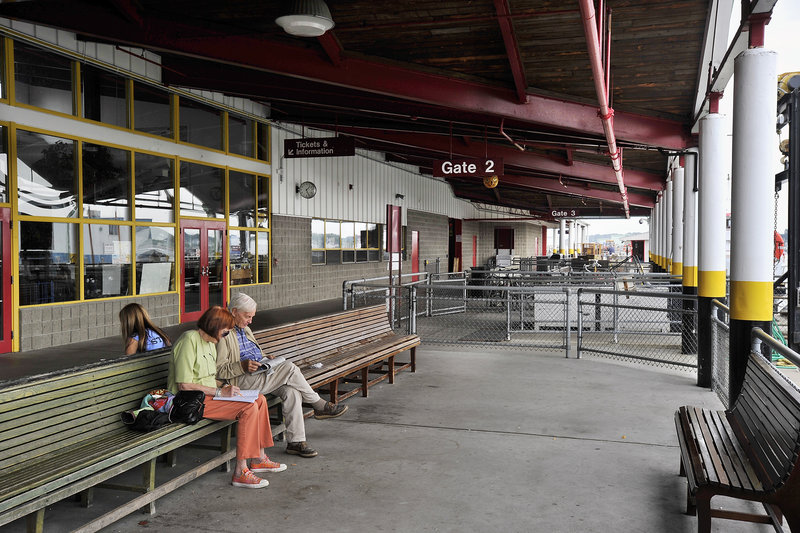 Travelers sit in the outside waiting area of the Casco Bay Ferry Terminal in Portland on Saturday. A renovation and expansion project will make the terminal “better, particularly for the customers,” Operations Agent Larry Legere said.