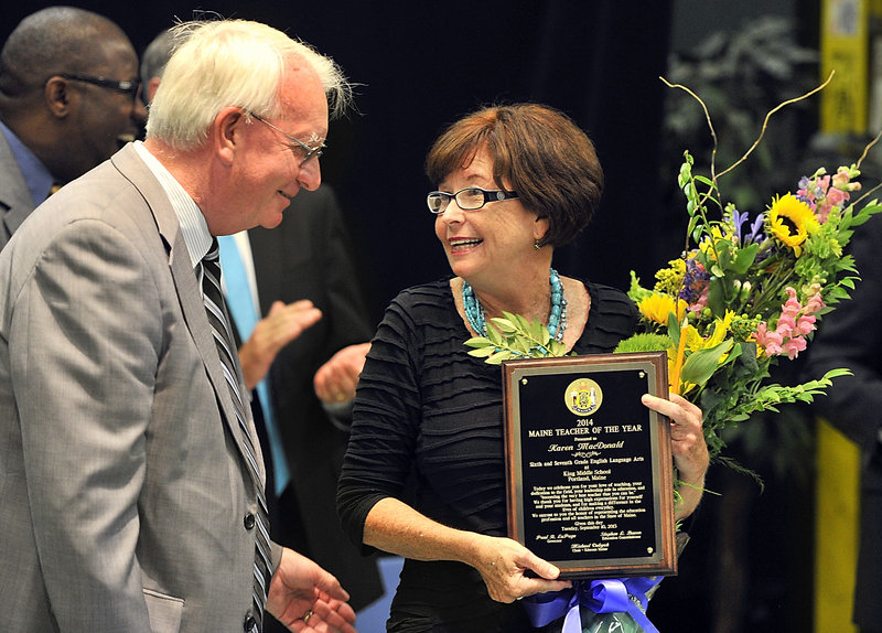 Teacher Karen MacDonald shares a moment with Middle School Principle Michael McCarthy after she was named Maine Teacher of the Year on Tuesday, Sept. 10, 2013 at an assembly at King Middle School in Portland.