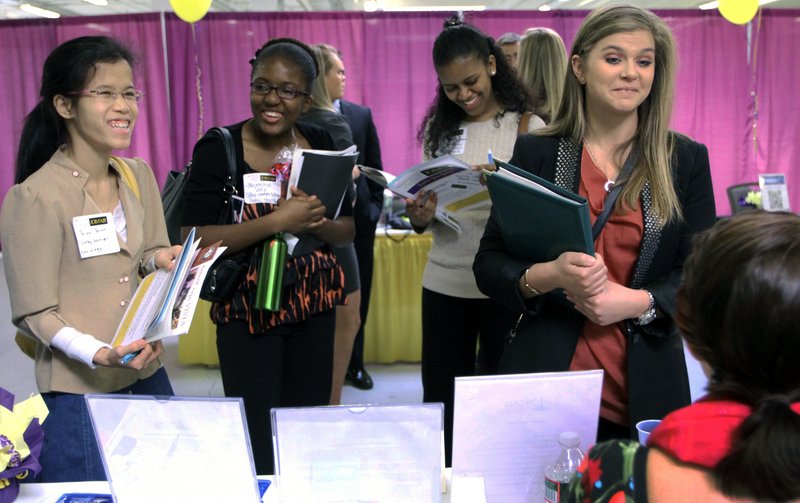 Martina Ryberg, right, of Plymouth State University, talks with a recruiter during a job fair for college students in Manchester, N.H. A new report shows women have recovered all the jobs they lost during the recession.