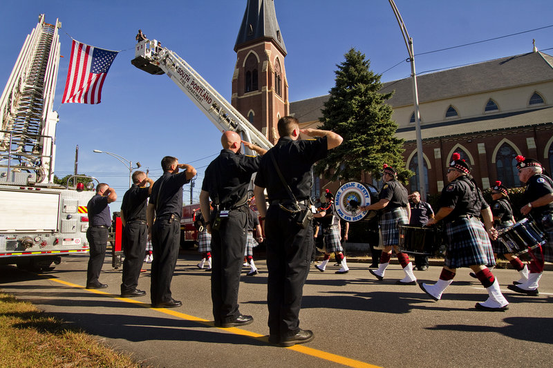 Firefighters salute a color guard leading the way to the Cathedral of the Immaculate Conception in Portland for the annual Blue Mass on Sunday. Hundreds of local, state and federal law enforcement officers, firefighters and other public safety workers were recognized during the Mass for their service.