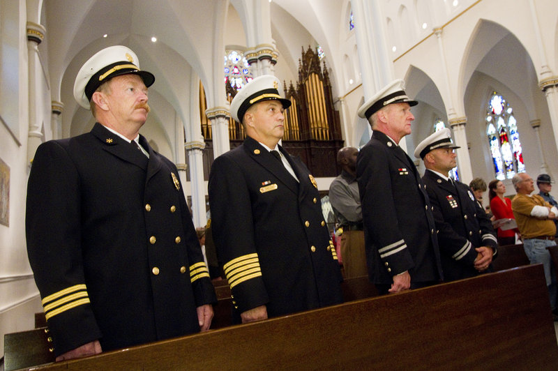 Portland Fire Department Deputy Chief William Flynn, from left, Chief Jerome LaMoria, Capt. John Cannon and Capt. Keith Gautreau attend the Blue Mass on Sunday.