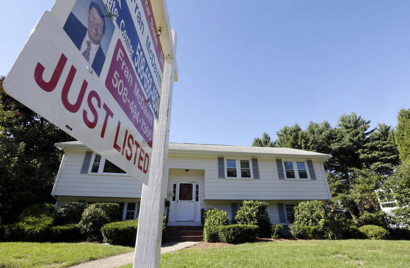 A sale sign hangs outside a house in Walpole, Mass. U.S. single-family home sales rose in August to the highest level since February 2007 and median prices jumped 14.4 percent as buyers rushed to close deals before interest rates rise.