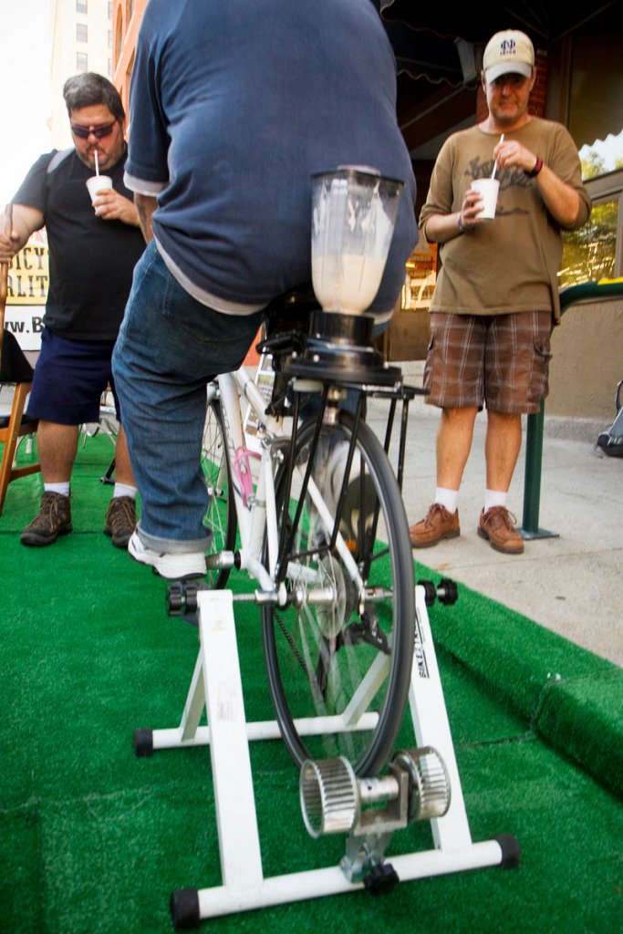 Frank Dorazio (L) and Brian Chabak of Portland (R) enjoy a milkshake made with peddle power in a parking space outside the Bicycle Coalition of Maine Preble Street office Friday. Sept. 20, 2013 during Portland's second annual Park(ing) Day. Taking place in nearly 200 cities around the world, people take over parking spaces for to hang out and have fun.