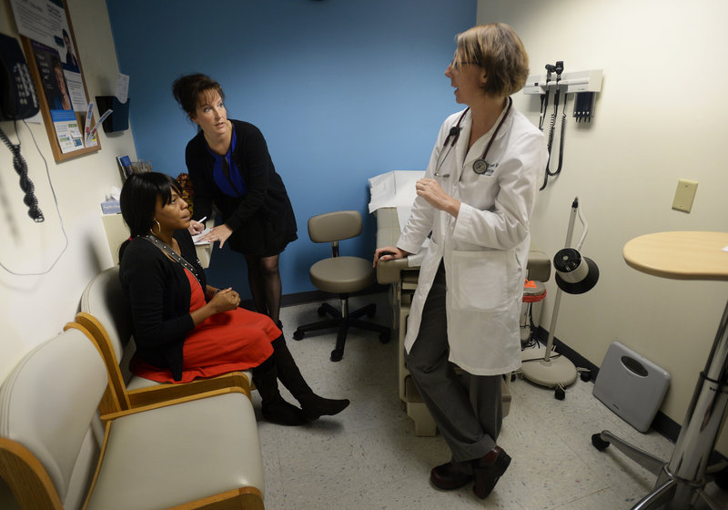 Dr. Elizabeth Frutiger, right, talks with Mireille Kabongo, left, of Portland and caseworker Michelle Bartlett of Westbrook during a visit to the Portland Community Heath Center.
