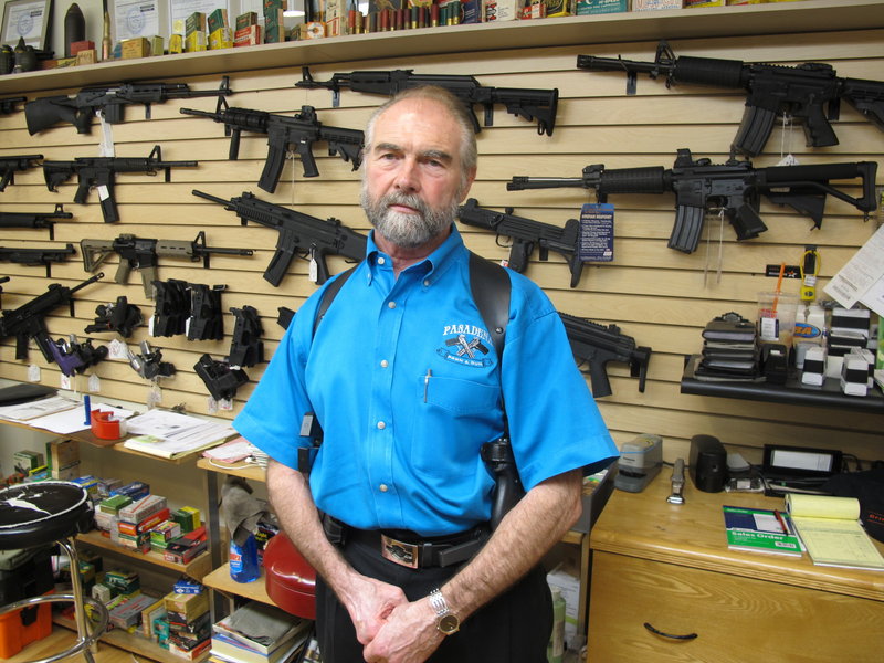 Frank Loane with assault rifles at his store in Pasadena, Md., on Thursday.