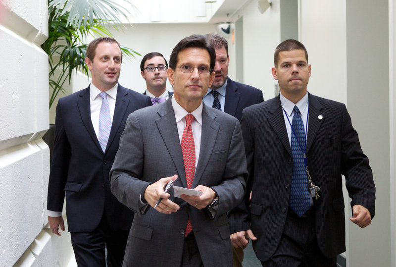 House Majority Leader Eric Cantor of Virginia walks out of a Republican caucus at the Capitol in Washington on Saturday. Lawmakers from both parties urged one another in a rare weekend session to give ground in their fight over preventing a federal shutdown.
