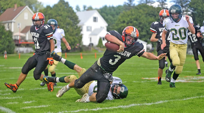 Winslow High School's Dylan Hapworth, 3, breaks away from Mount Desert ISland High School's Dakota Stewart, 10, in Winslow on Saturday. Winslow defeated MDI 49-18.