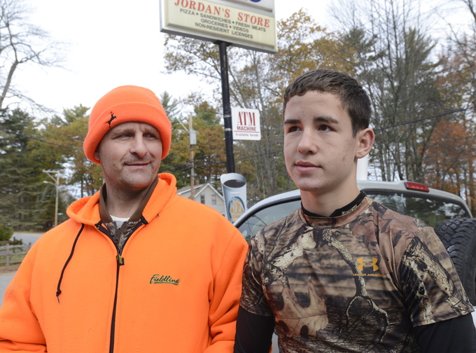 Joseph Kenney, right, and his dad, Joe Kenney, take a break from hunting on Saturday, at Jordan’s Store in Sebago.