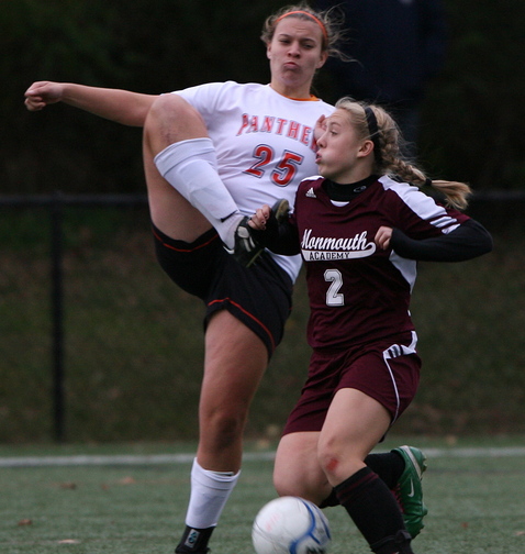 Haley Fletcher, right, of Monmouth Academy tries to shield the ball away from North Yarmouth Academy’s Mary Noyes.